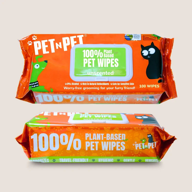 Pet n Pet 100% plant-based unscented pet wipes shown from front and back with orange packaging, featuring cute cartoon cat and dog graphics, natural ingredient icons, and 100-wipe count.