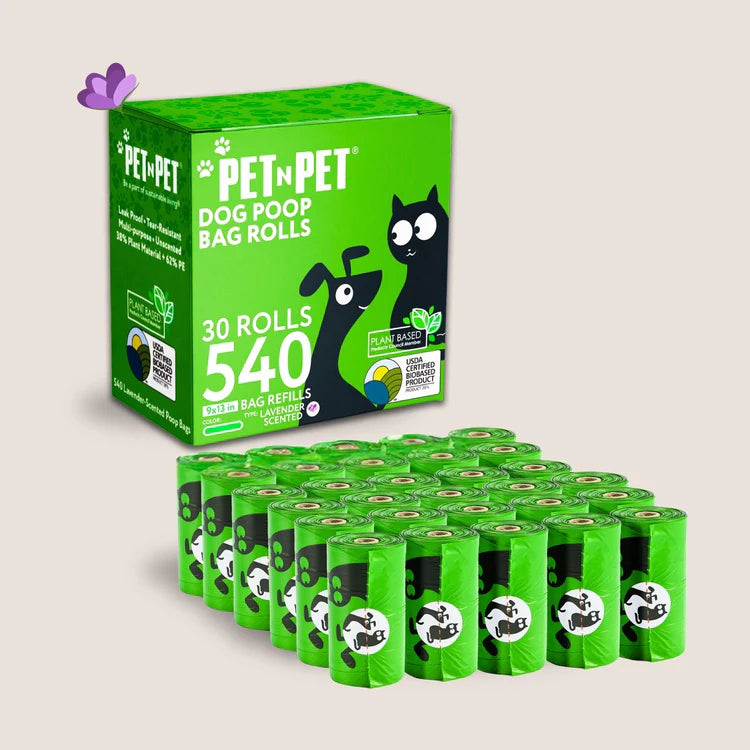 Pet n Pet dog poop bag rolls in bright green packaging containing 30 rolls with 540 bags total, displayed with matching green roll refill dispensers.