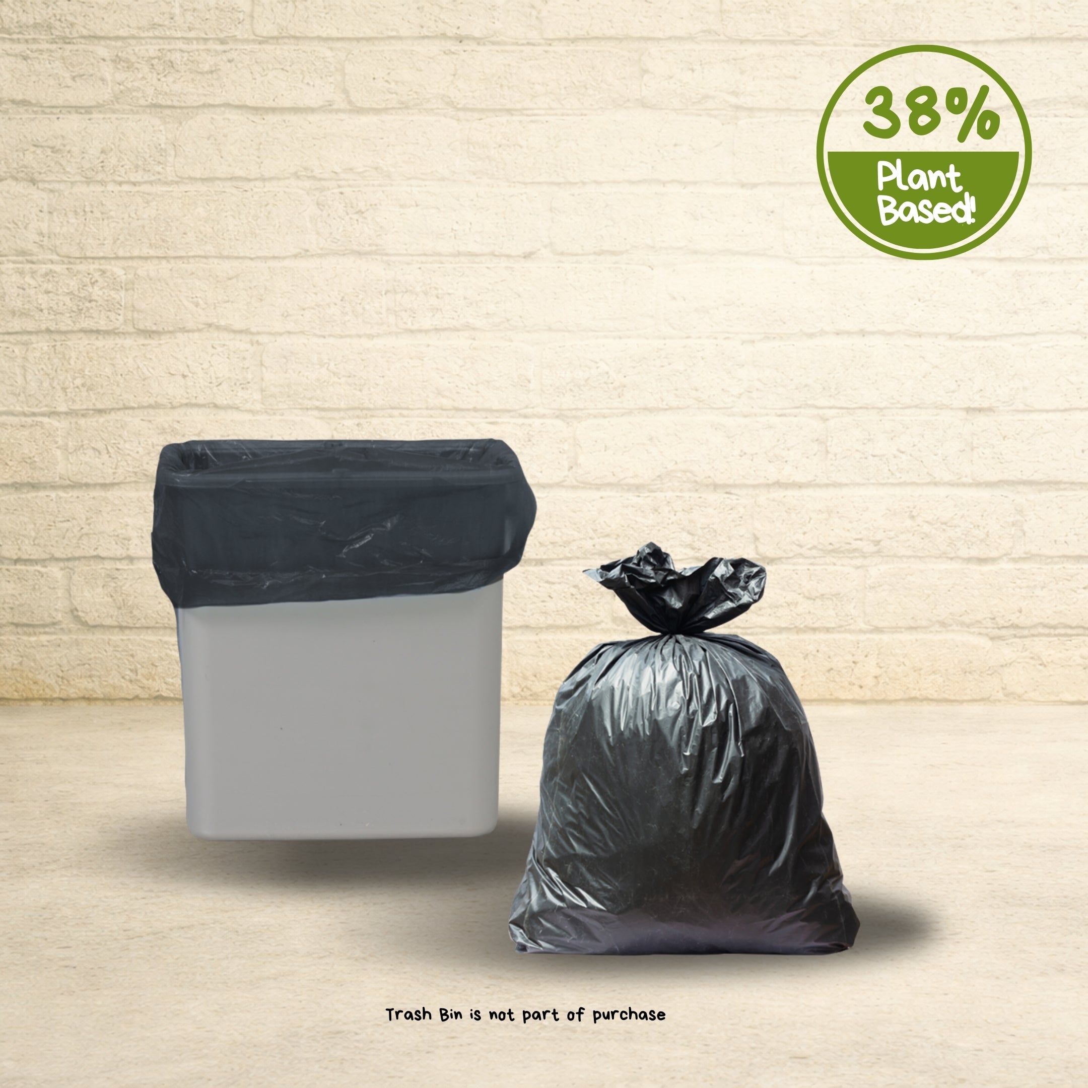 Black plant-based trash can liner inside a white bin with a tied bag beside it showing 38 percent plant-based material badge.