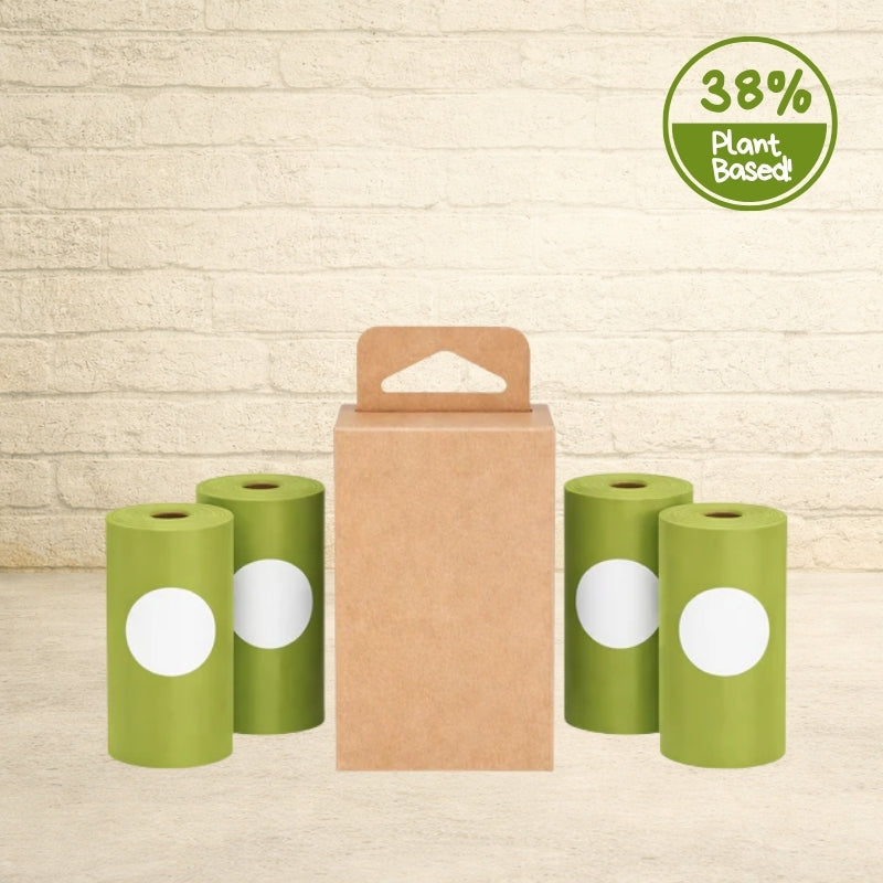 Original Poop Bags 38% plant-based green dog poop bag rolls displayed around a brown cardboard carrier box.