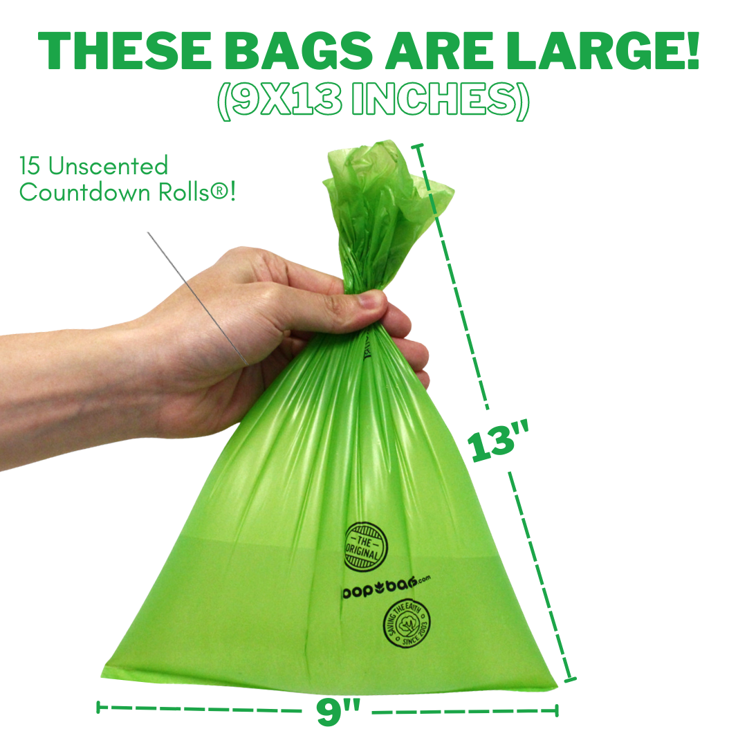Hand holding a large 9 by 13 inch green unscented Countdown Rolls dog poop bag.