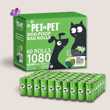 Pet n Pet Dog Poop Bag Rolls green box featuring cartoon dog & cat graphics, labeled 60 rolls/1,080 lavender-scented 9x13 bags, with plant-based & USDA biobased badges and matching green rolls lined up in front